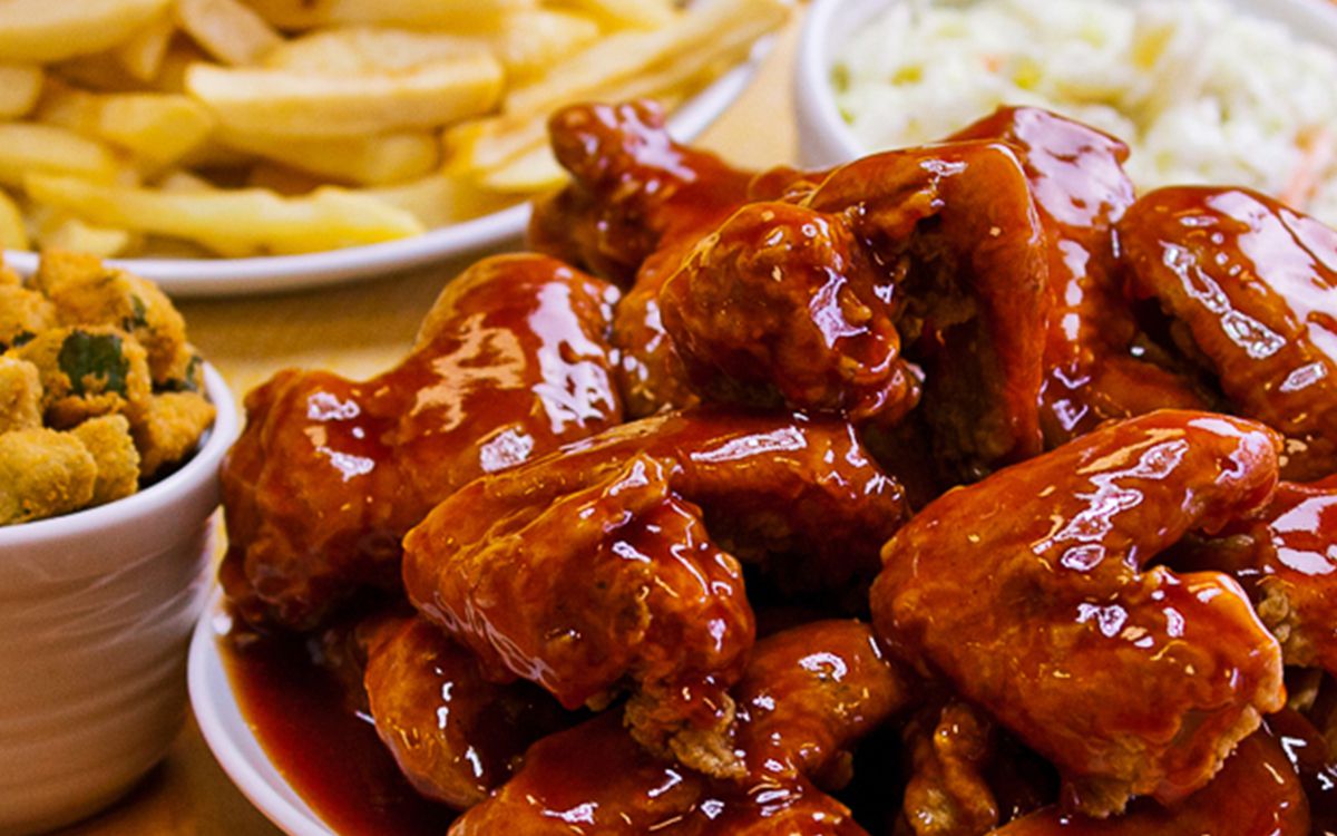 A plate of chicken wings smothered in sauce