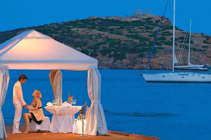 Couple during a romantic dining by the sea in Athens in Greece