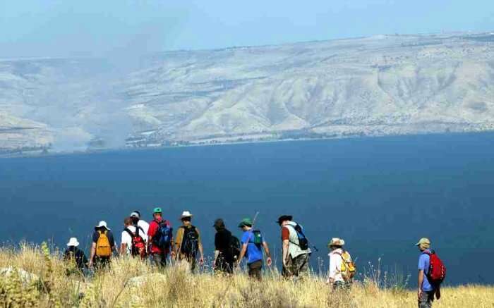 Hikers walking past Sea of Galilee in Israel