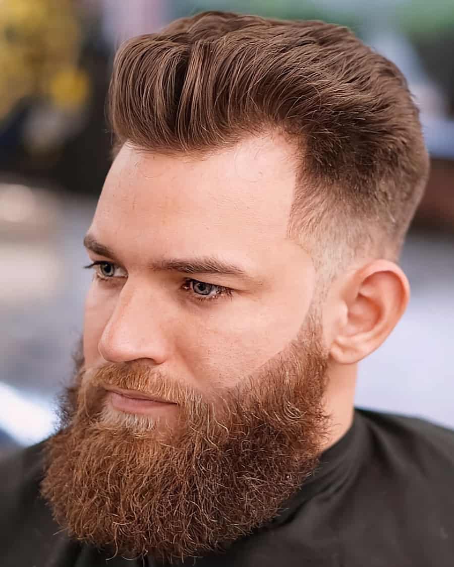 Men's mid-length blown out hair with a low fade