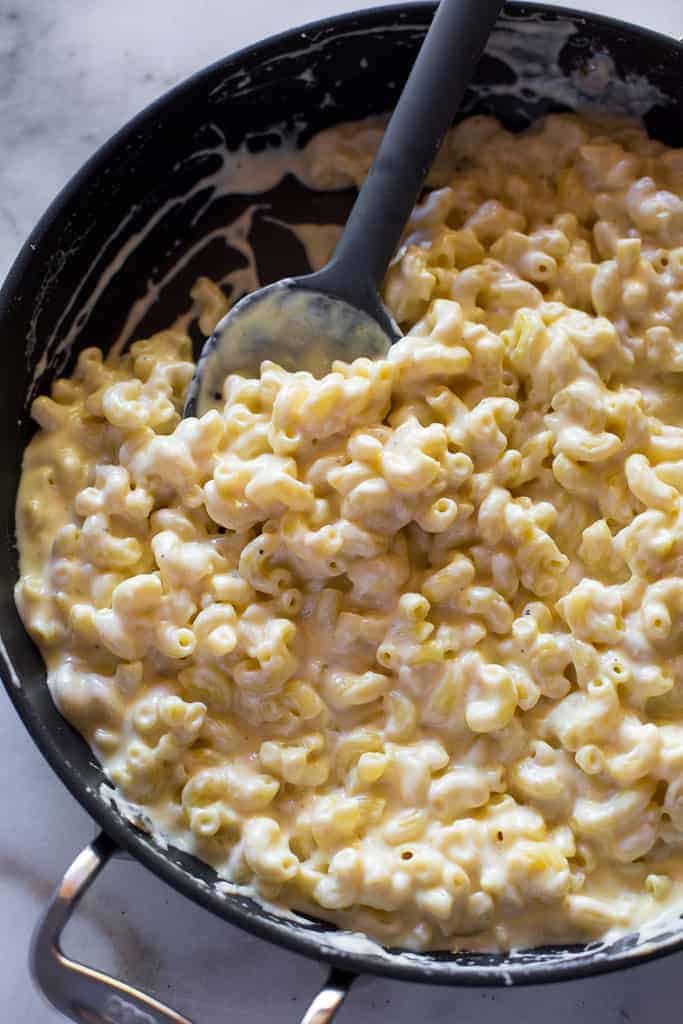 Overhead view of a skillet with homemade macaroni and cheese, ready to eat.
