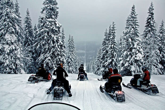 Snowbikers pass through the border of Norway and Sweden