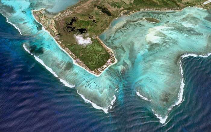 This underwater wonder of the world is located in the Indian Ocean and is surrounded by white sandy beaches.