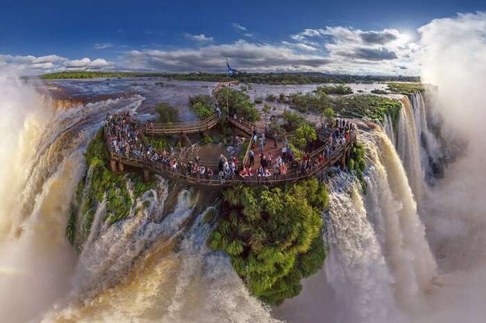 Tourists gather at the top of the Iguazu Falls at the border of Argentina and Brazil