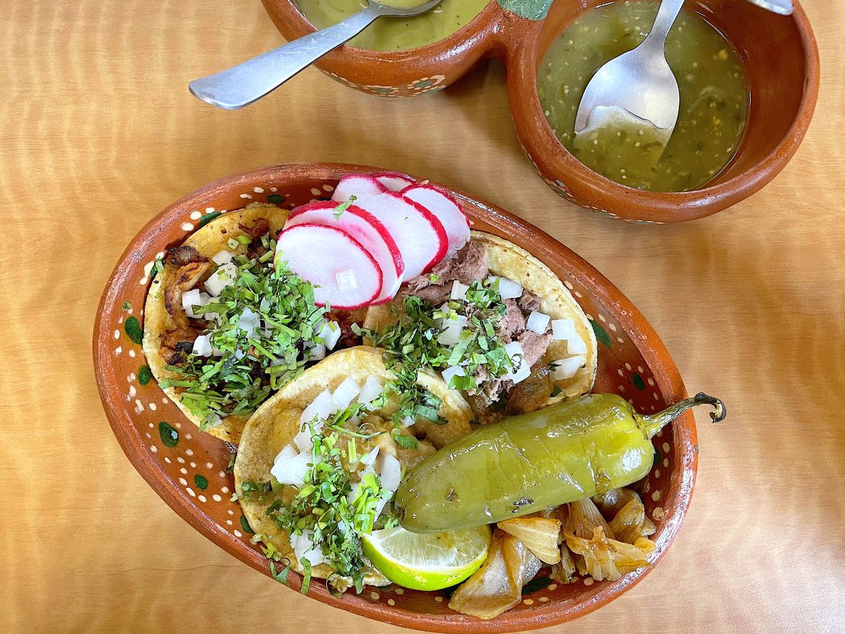 Birria taco with bone marrow, pork chop taco with cactus, and pollo pibil with avocado.
