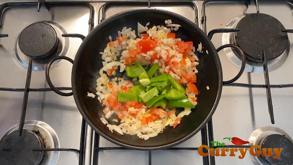 Adding tomato puree to the pan